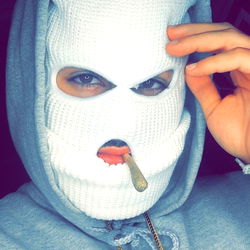 Masked Individual with Cigar in Mouth