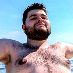 Shirtless Man with Beard Enjoys Time on Boat