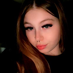 Lane, OnlyFans Model with Dark Hair and Tattoos, Posting Selfie on Instagram