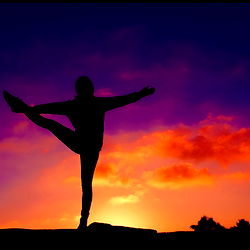 Silhouette of a Person Practicing Yoga at Sunset