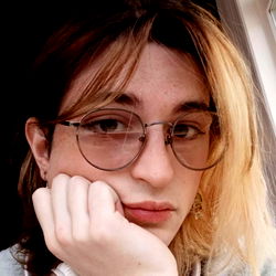 Lonely Girl with Blonde Hair and Glasses, Resting Her Head on her Hand