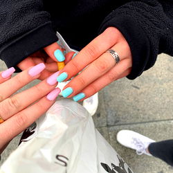 Person Applying Nail Polish in Public