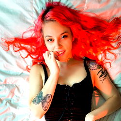 Model with vibrant hair in a relaxed pose, 2021