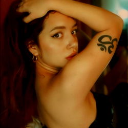 Stylish and Confident Astrid Showcasing Her Tattoo