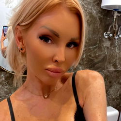 A Blonde Model in a Bathroom Mirror