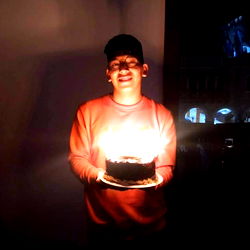 A young man celebrating his birthday with a cake