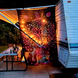 Nighttime Camping Scene with RV Trailer and Tent