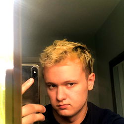 Young Male Model in Bathroom Mirror