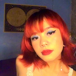 Luna with Vivid Red Hair and Blue Eye Shadow