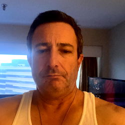 Man in Tank Top Taking Selfie