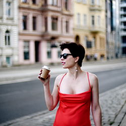 Woman in Red Dress Posing on Street