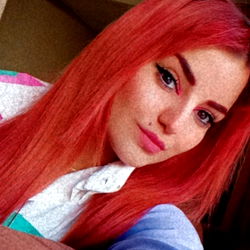 Anairam in a Colorful Shirt and Red Hair