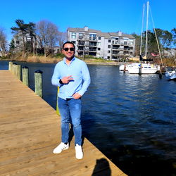 A young man posing on a dock