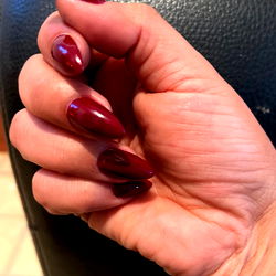 Fingernails with Red Polish and Sharp Pointed Claws