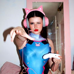 OnlyFans Model Emily in Playful Outfit and Gaming Accessories