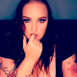 Mandiiii from Ohio, a tattooed beauty posing with hand on face