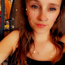 Hotmessmama, a young adult, striking a pose for the camera.