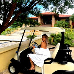 Isabella's Relaxing Moment on a Golf Cart