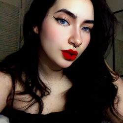 Aglael, a captivating OnlyFans model with striking blue eyes and red lips