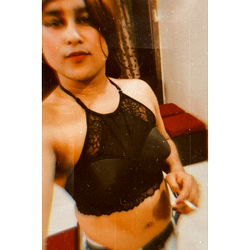 A Woman Taking a Mirror Selfie in a Bra and Jeans