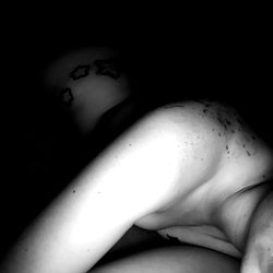 Intimate, black and white image of Alexandra Lynn in a cozy setting,