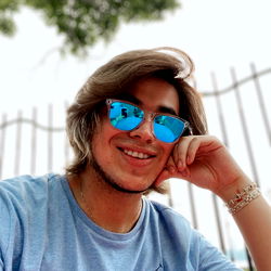 Stavros: A Smiling Man in Blue Sunglasses
