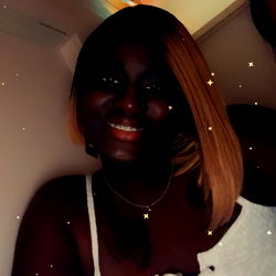 Chocolate T, Onlyfans Model, Smiling in a White Tank Top