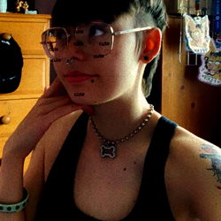 Person in glasses posing with hand on face