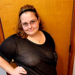 Full-Length, Color Photo of a Smiling Woman Posing Indoors