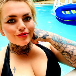 Olivia Makenna posing by pool in summer attire