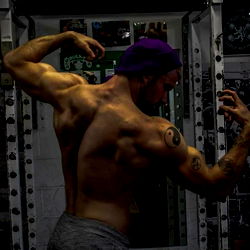 Muscular Man Showcasing His Back in Gym Mirror