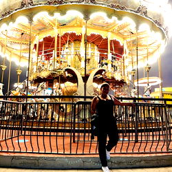 Woman standing in front of a merry-go-round