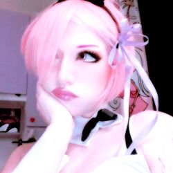 Vintage-style cosplay of a bunny model with exaggerated features, set against a purple wall. OnlyFans Italy