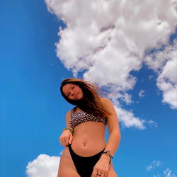 Astrid in a Beach Bikini Standing Against Blue Sky