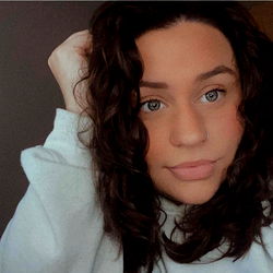 A Young Woman Smiling at the Camera