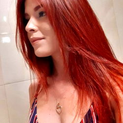 Sagitariana, a vibrant red-haired model in the spotlight