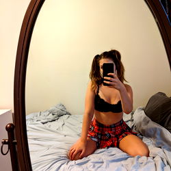Young Woman Posing in Bedroom Mirror