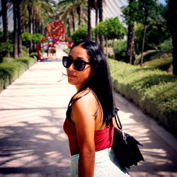 Woman at a Palm Tree-Lined Path in a Park