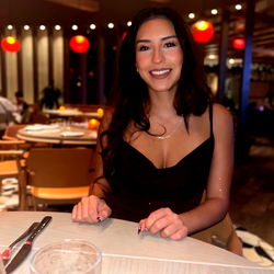 Woman Smiling at Camera in Restaurant