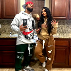 Model DedricandKat with another person posing in a kitchen setting