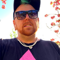 Bearded Man with Pink Hat and Neon Sign