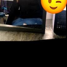 A woman taking a selfie in front of a mirror