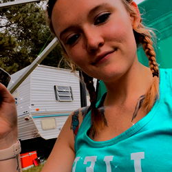 Anna on a camper, holding a phone