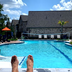 A Person Relaxing at a Swimming Pool