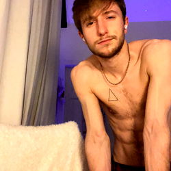 Onlyfans Model Alex Now: Shirtless, Tattooed, and Leaning Against Blurred Background