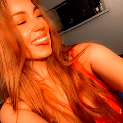 Lexi, a vibrant red-headed model striking a pose