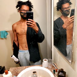 Fitness-focused individual showcasing body transformation in bathroom mirror reflection, Phoenix AZ