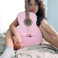A Person Holding a Guitar in a Room