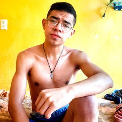 A 25-year-old man with a beard in a bathroom setting