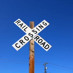 Railroad Crossing with Signal Sign in Rural Area